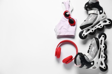 Photo of Flat lay composition with roller skates on white background. Space for text