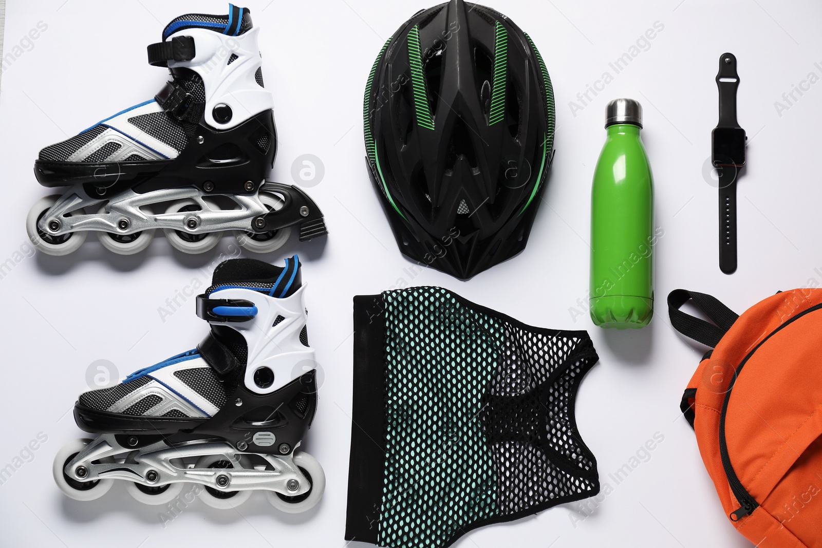 Flat lay composition with roller skates on white background Photo of Flat lay composition with roller skates on white background