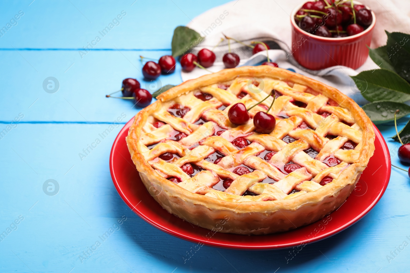 Tasty cherry pie on light blue wooden table, closeup. Space for text Photo of Tasty cherry pie on light blue wooden table, closeup. Space for text