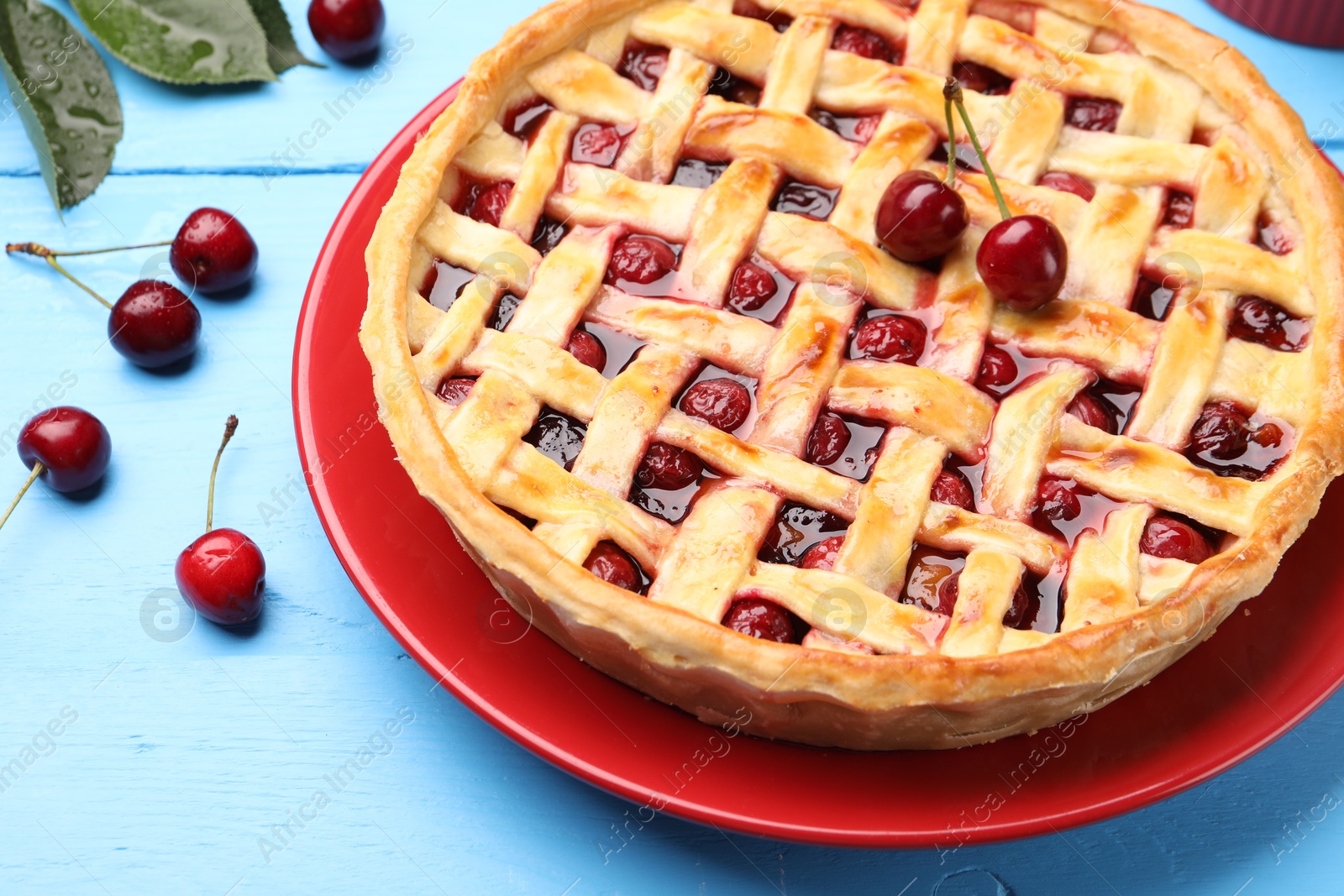 Tasty cherry pie on light blue wooden table, closeup Photo of Tasty cherry pie on light blue wooden table, closeup