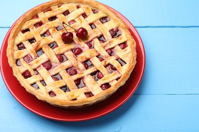 Photo of Tasty cherry pie on light blue wooden table, closeup