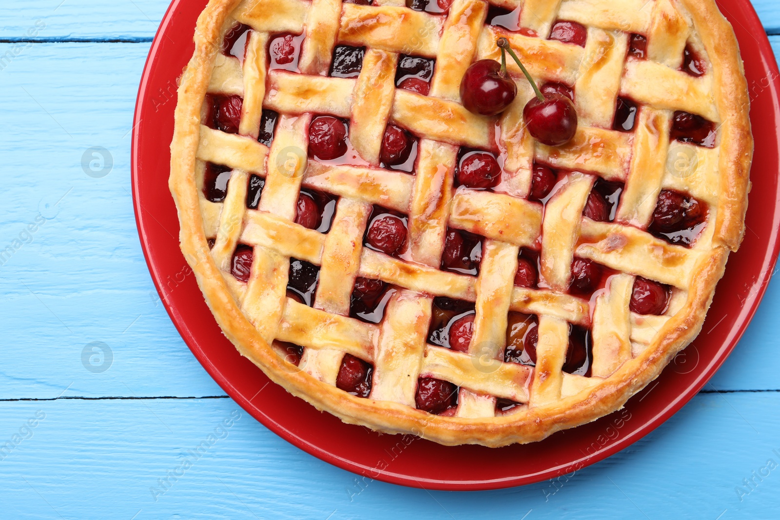 Tasty cherry pie on light blue wooden table, top view Photo of Tasty cherry pie on light blue wooden table, top view