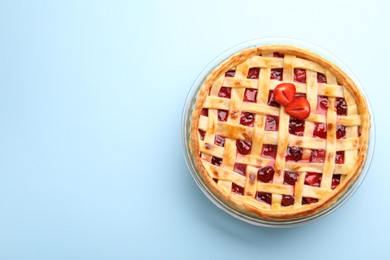Photo of Tasty strawberry pie on light blue background, top view