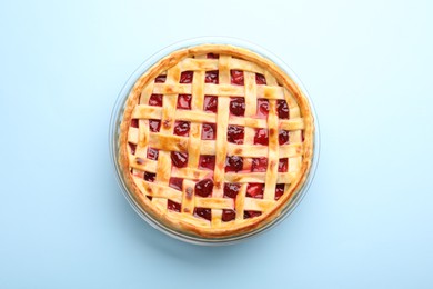 Photo of Tasty strawberry pie on light blue background, top view