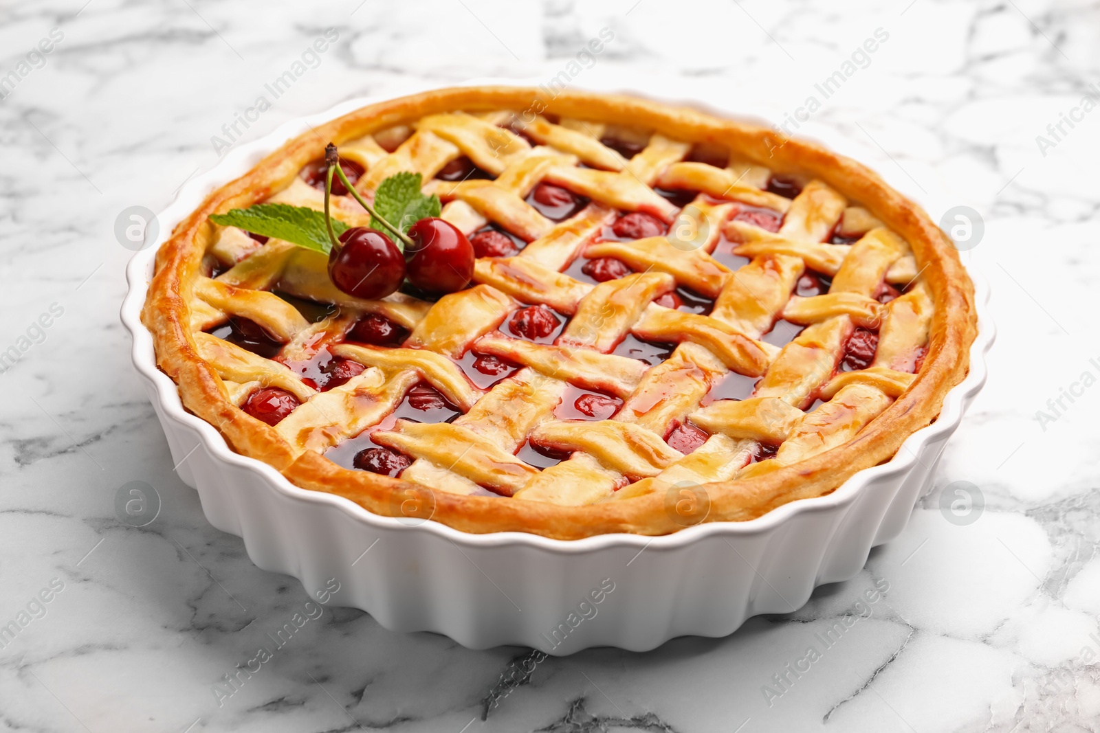 Photo of Tasty cherry pie on white marble table, closeup