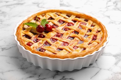 Photo of Tasty cherry pie on white marble table, closeup