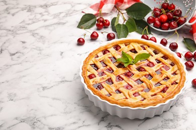 Photo of Tasty cherry pie and berries on white marble table, closeup. Space for text