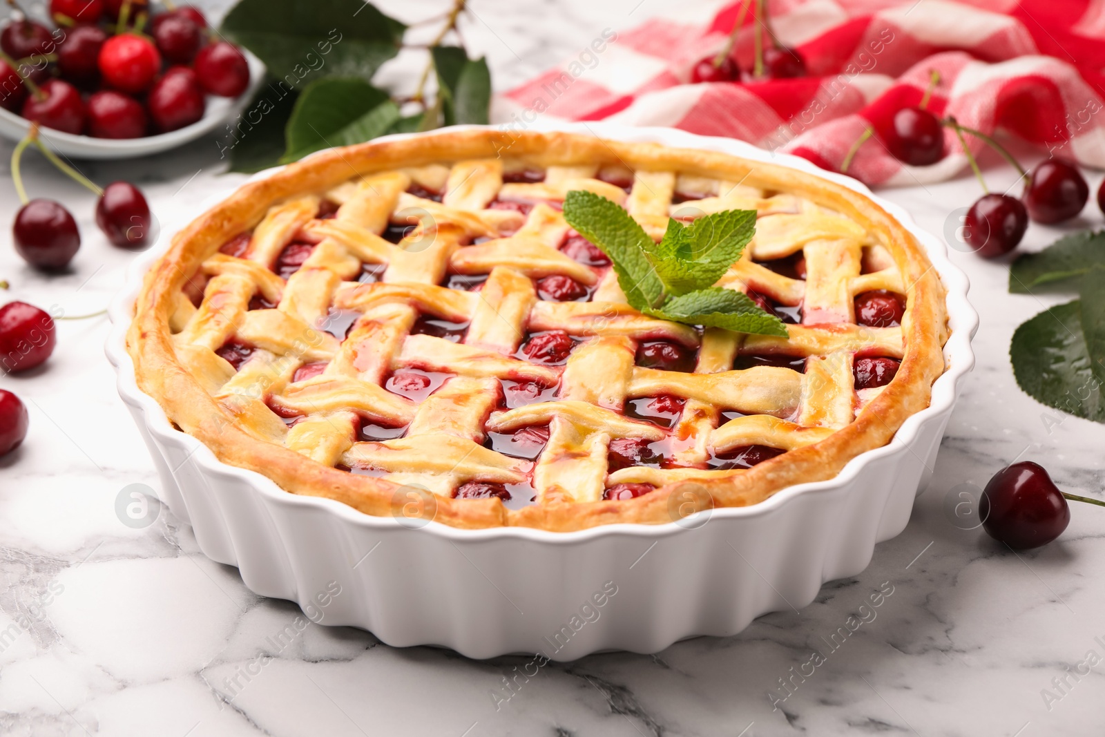 Tasty cherry pie and berries on white marble table, closeup Photo of Tasty cherry pie and berries on white marble table, closeup