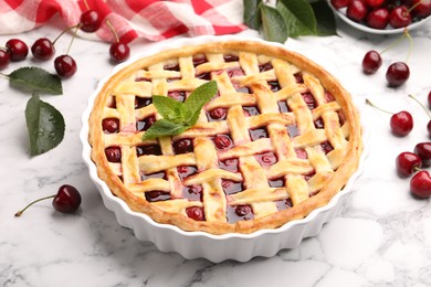 Photo of Tasty cherry pie and berries on white marble table, closeup