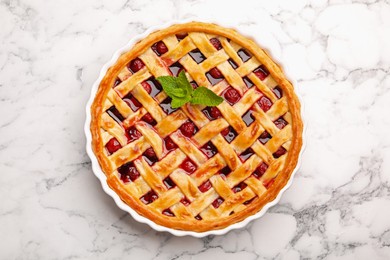 Photo of Tasty cherry pie on white marble table, top view