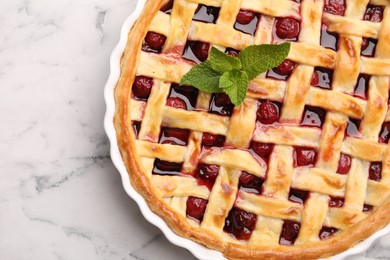 Photo of Tasty cherry pie on white marble table, top view
