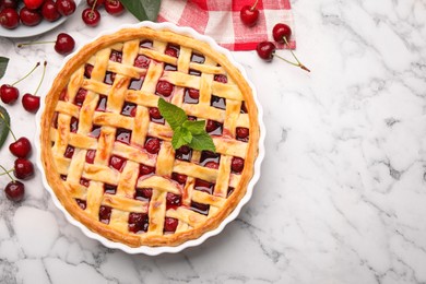 Photo of Tasty cherry pie and berries on white marble table, flat lay. Space for text