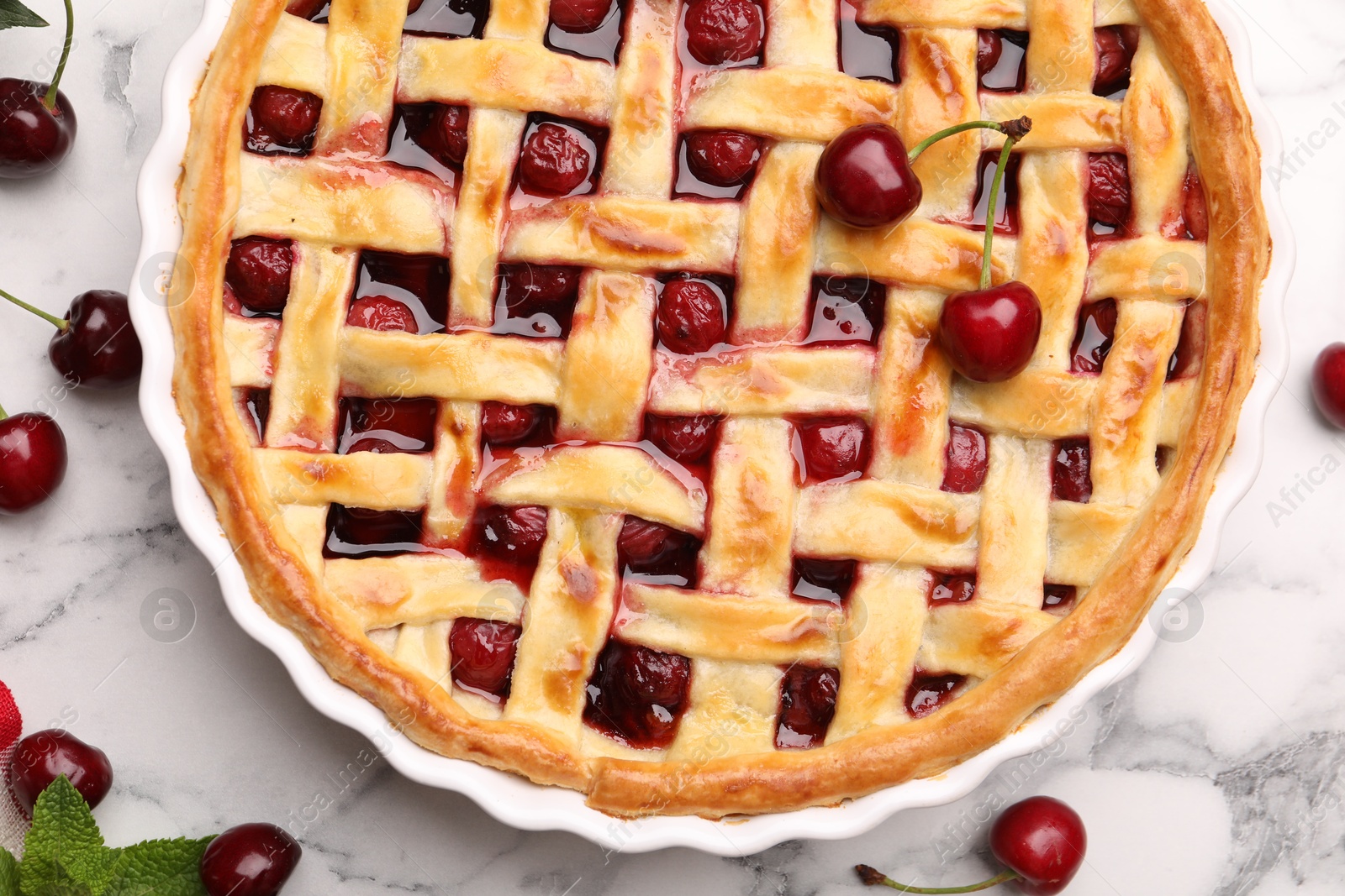 Tasty cherry pie and berries on white marble table, flat lay Photo of Tasty cherry pie and berries on white marble table, flat lay