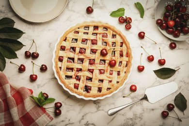 Photo of Tasty cherry pie and berries on white marble table, flat lay