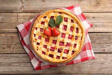 Photo of Tasty strawberry pie on wooden table, top view