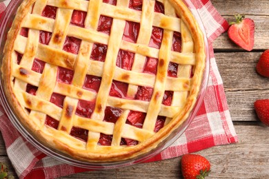 Photo of Tasty strawberry pie and berries on wooden table, flat lay