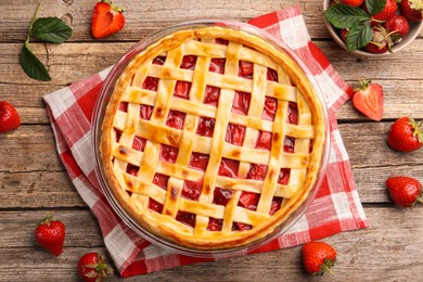 Photo of Tasty strawberry pie and berries on wooden table, flat lay