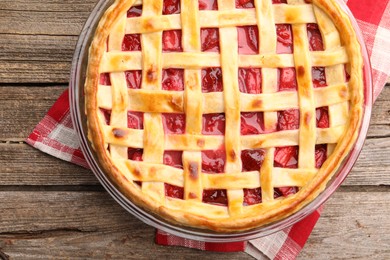 Photo of Tasty strawberry pie on wooden table, top view