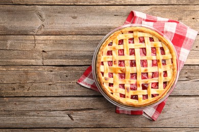 Photo of Tasty strawberry pie on wooden table, top view