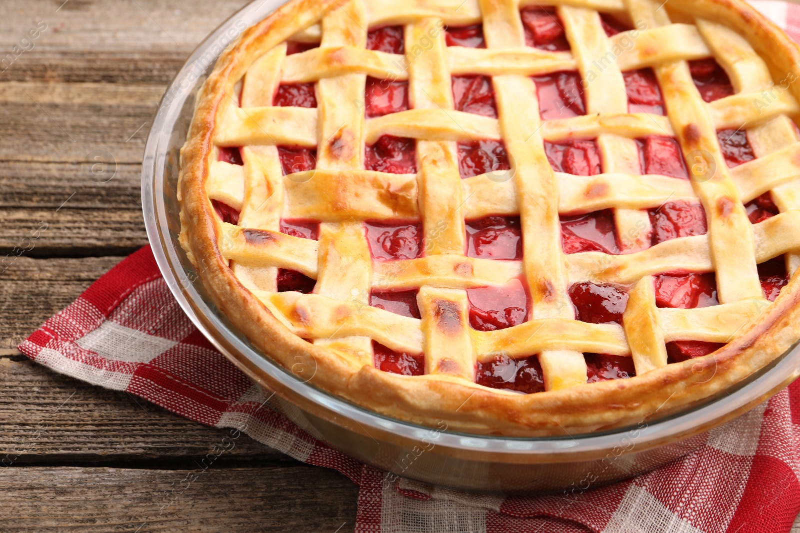 Photo of Tasty strawberry pie on wooden table, closeup
