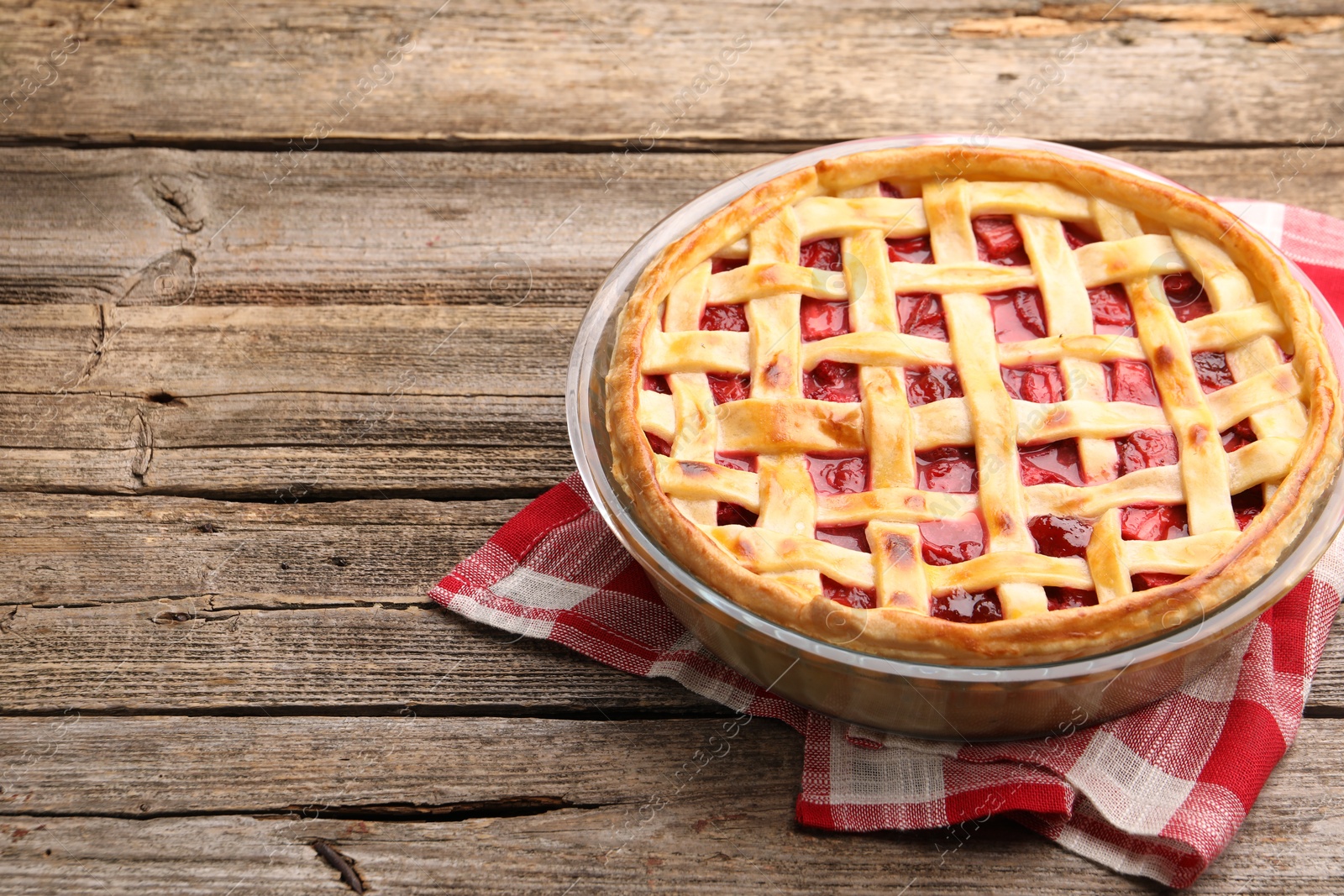 Photo of Tasty strawberry pie on wooden table, space for text