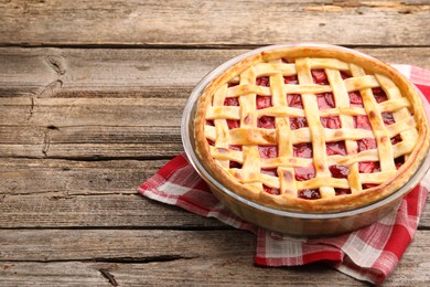 Photo of Tasty strawberry pie on wooden table, space for text