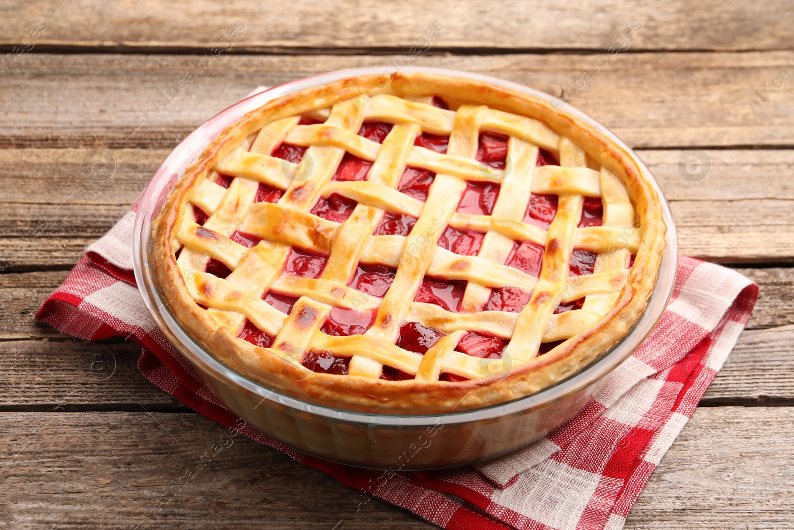 Photo of Tasty strawberry pie on wooden table, closeup