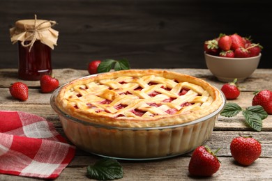 Photo of Tasty strawberry pie and berries on wooden table, closeup