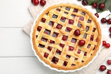 Photo of Tasty cherry pie and berries on white wooden table, flat lay
