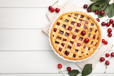 Photo of Tasty cherry pie and berries on white wooden table, flat lay. Space for text