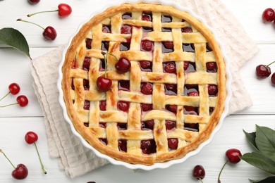 Photo of Tasty cherry pie and berries on white wooden table, flat lay
