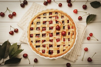 Photo of Tasty cherry pie and berries on white wooden table, flat lay