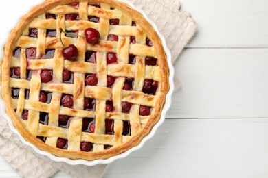 Photo of Tasty cherry pie on white wooden table, top view. Space for text