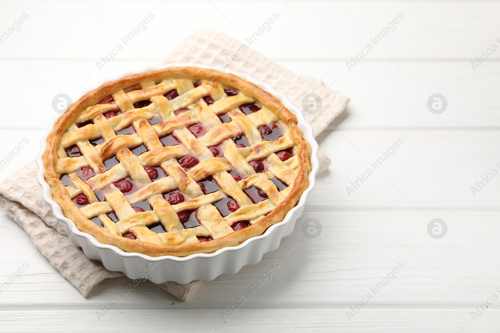 Tasty cherry pie on white wooden table, space for text Photo of Tasty cherry pie on white wooden table, space for text