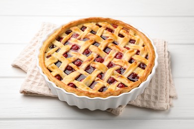 Photo of Tasty cherry pie on white wooden table