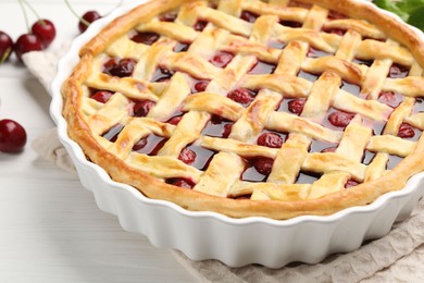 Photo of Tasty cherry pie and berries on white wooden table, closeup