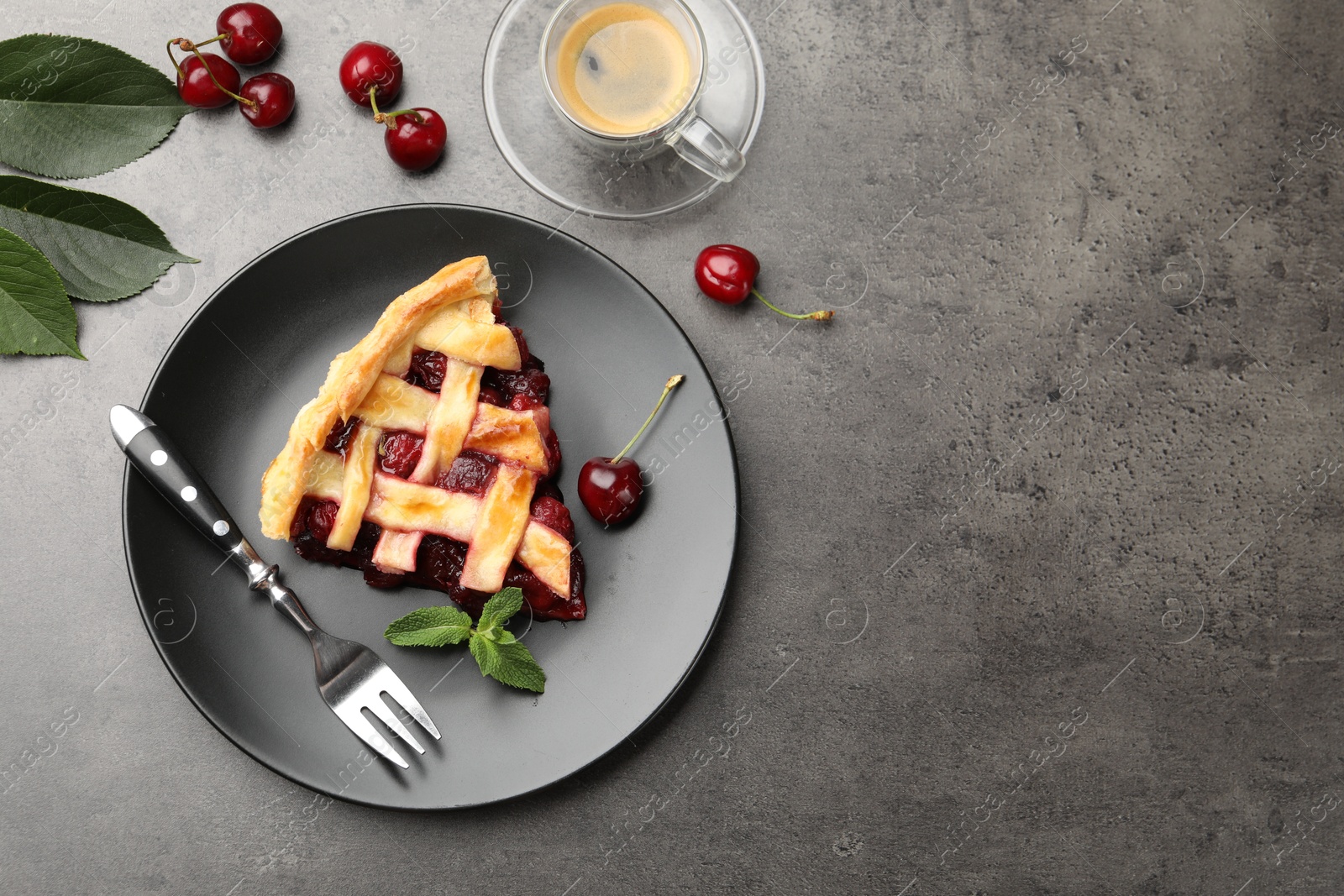 Photo of Piece of tasty cherry pie and berries on grey table, flat lay. Space for text