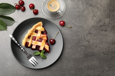 Photo of Piece of tasty cherry pie and berries on grey table, flat lay. Space for text