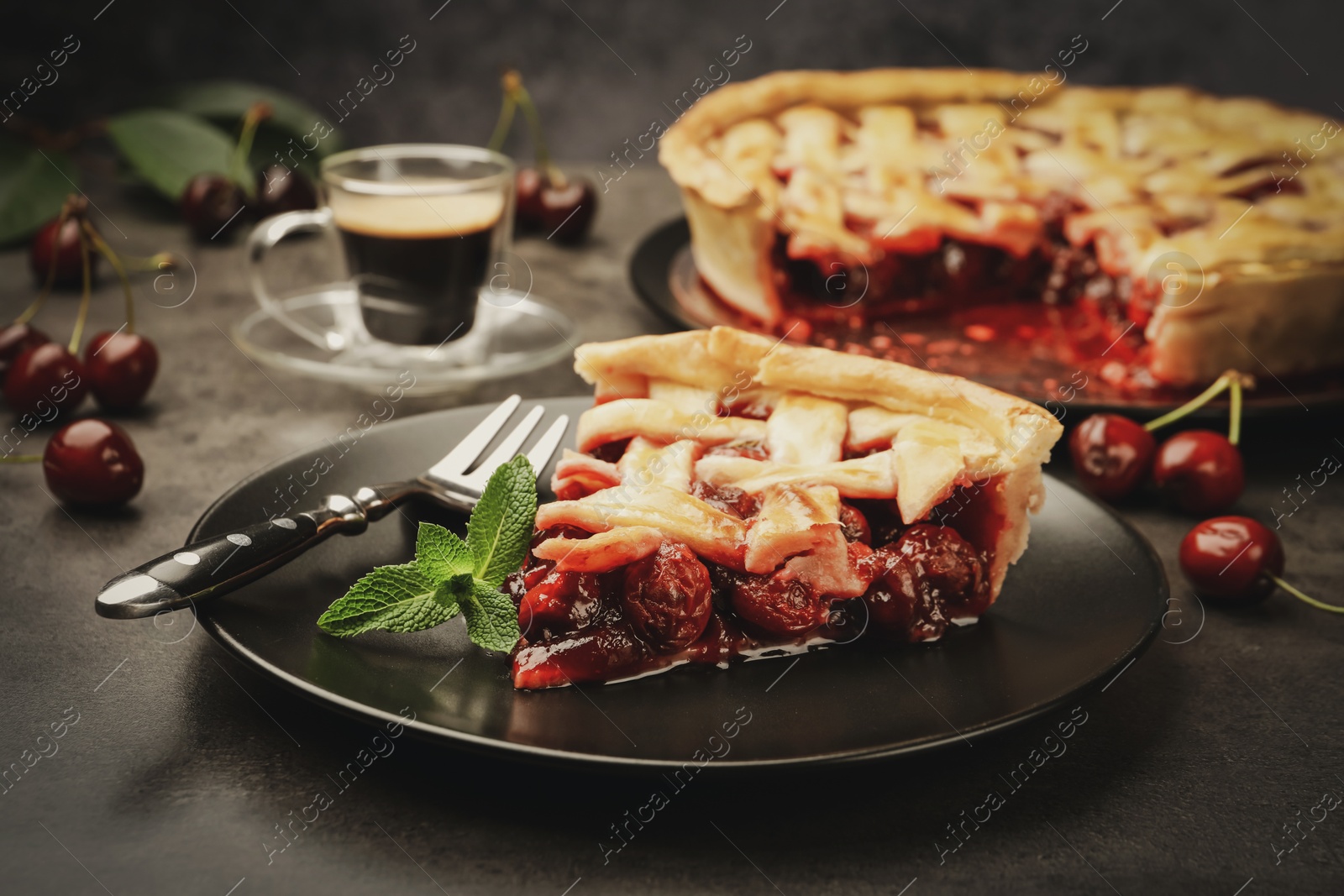 Piece of tasty cherry pie and berries on grey table, closeup Photo of Piece of tasty cherry pie and berries on grey table, closeup
