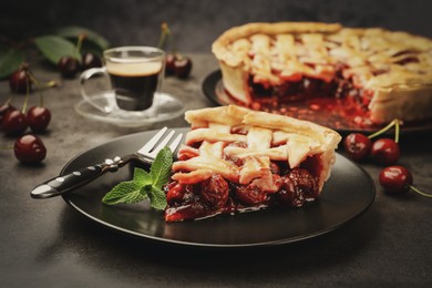 Photo of Piece of tasty cherry pie and berries on grey table, closeup