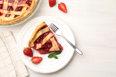 Photo of Piece of tasty strawberry pie and berries on white wooden table, flat lay. Space for text