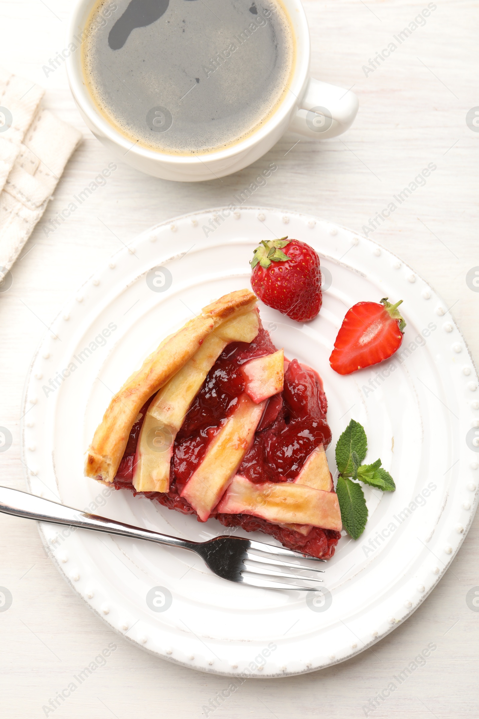 Piece of tasty strawberry pie and berries on white wooden table, top view Photo of Piece of tasty strawberry pie and berries on white wooden table, top view