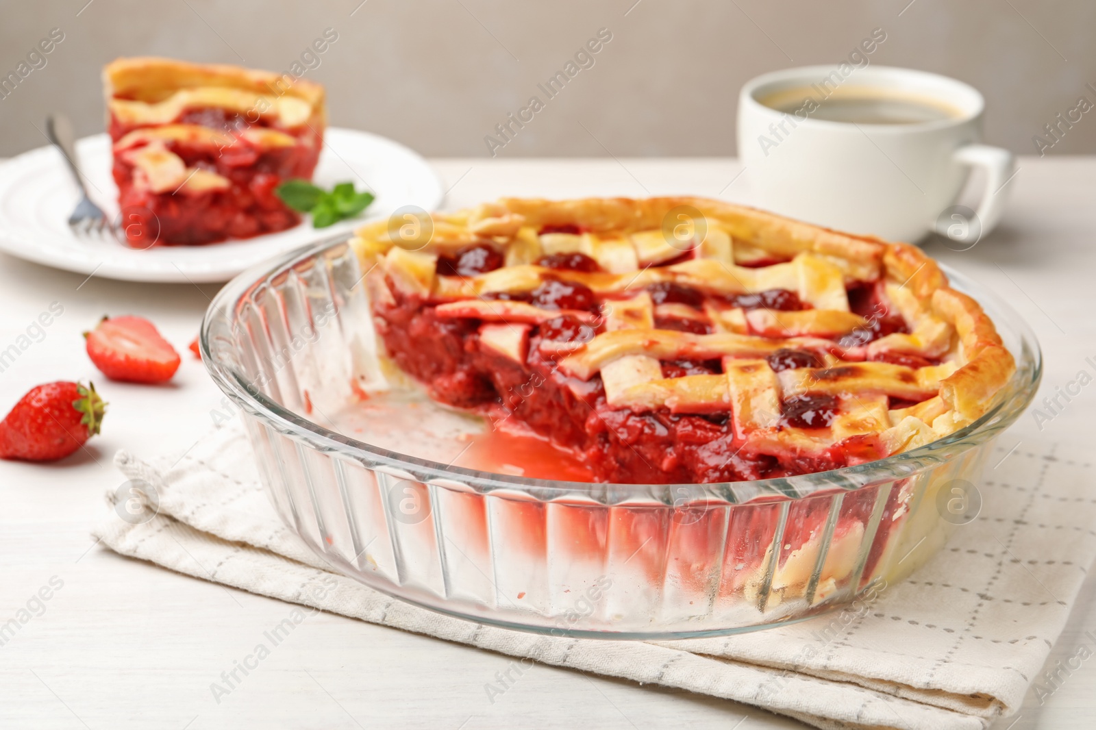 Tasty cut strawberry pie and berries on white wooden table, closeup Photo of Tasty cut strawberry pie and berries on white wooden table, closeup