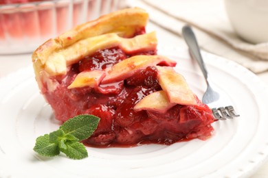 Photo of Piece of tasty strawberries pie on table, closeup