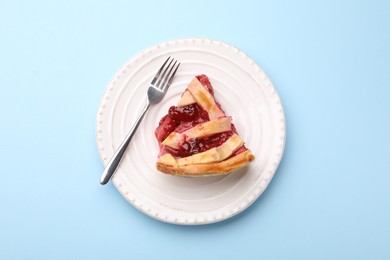Photo of Piece of tasty strawberry pie on light blue background, top view