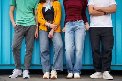 Photo of Group of teenagers near building outdoors, closeup