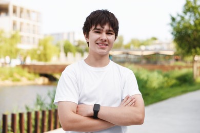Photo of Portrait of happy teenage boy posing outdoors