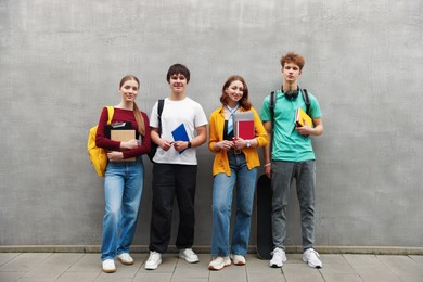 Photo of Group of teenagers posing near building outdoors