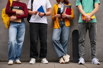 Photo of Group of teenagers posing near building outdoors, closeup