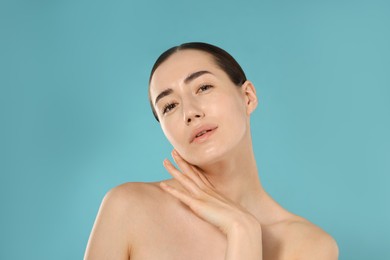 Photo of Beautiful woman after spa treatment on light blue background